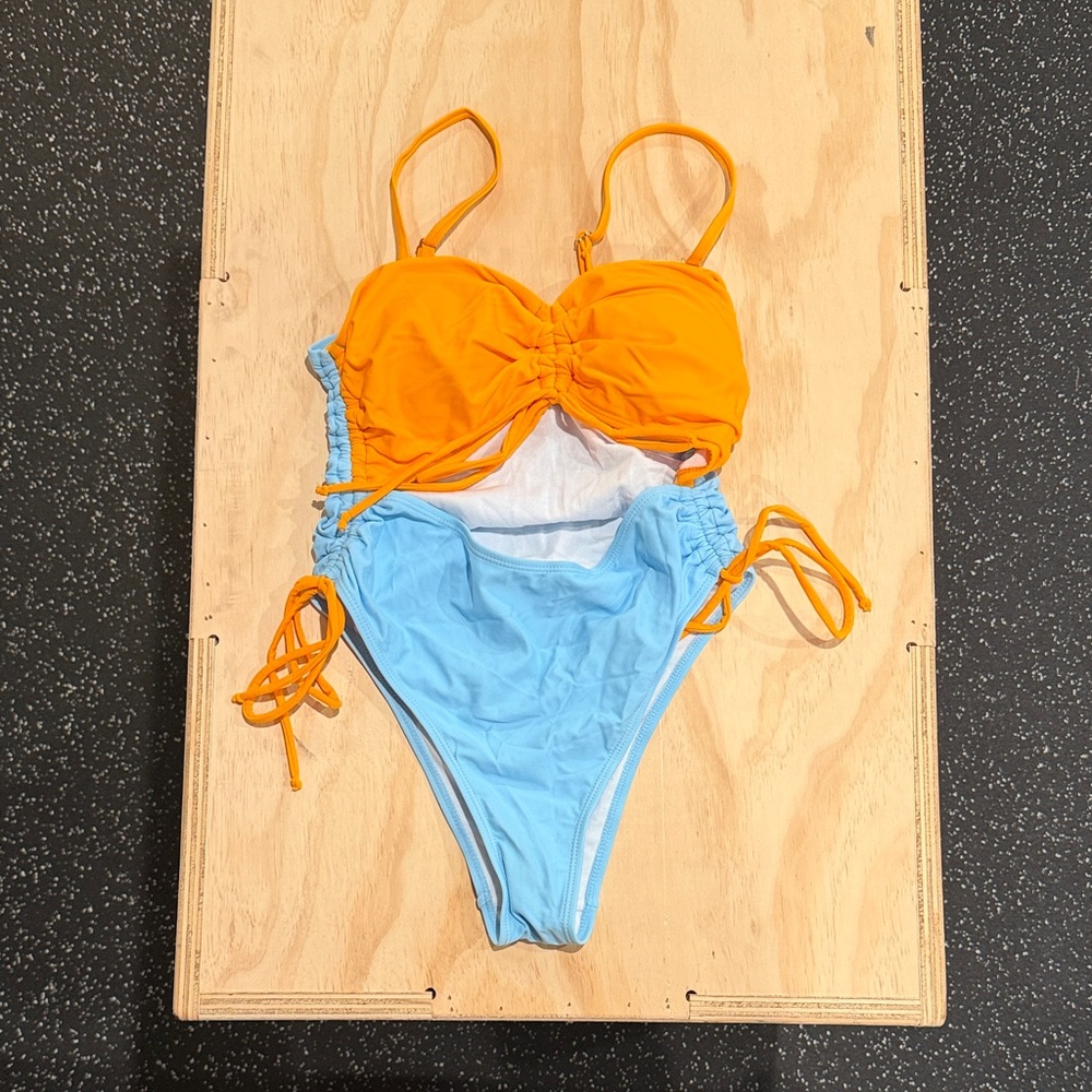 Orange and Blue One Piece Swimsuit with a stomach cut out